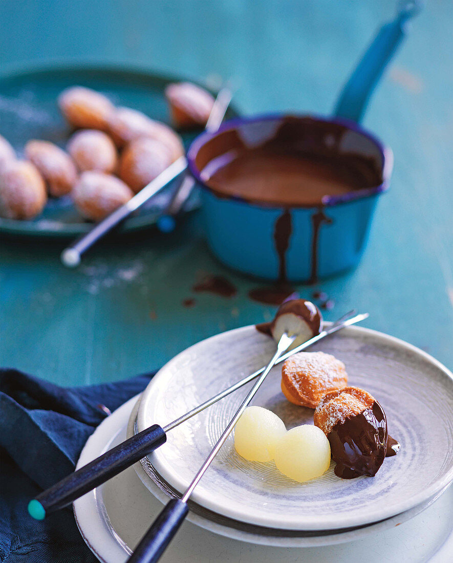 Chocolate fondue with poached pears and madeleines