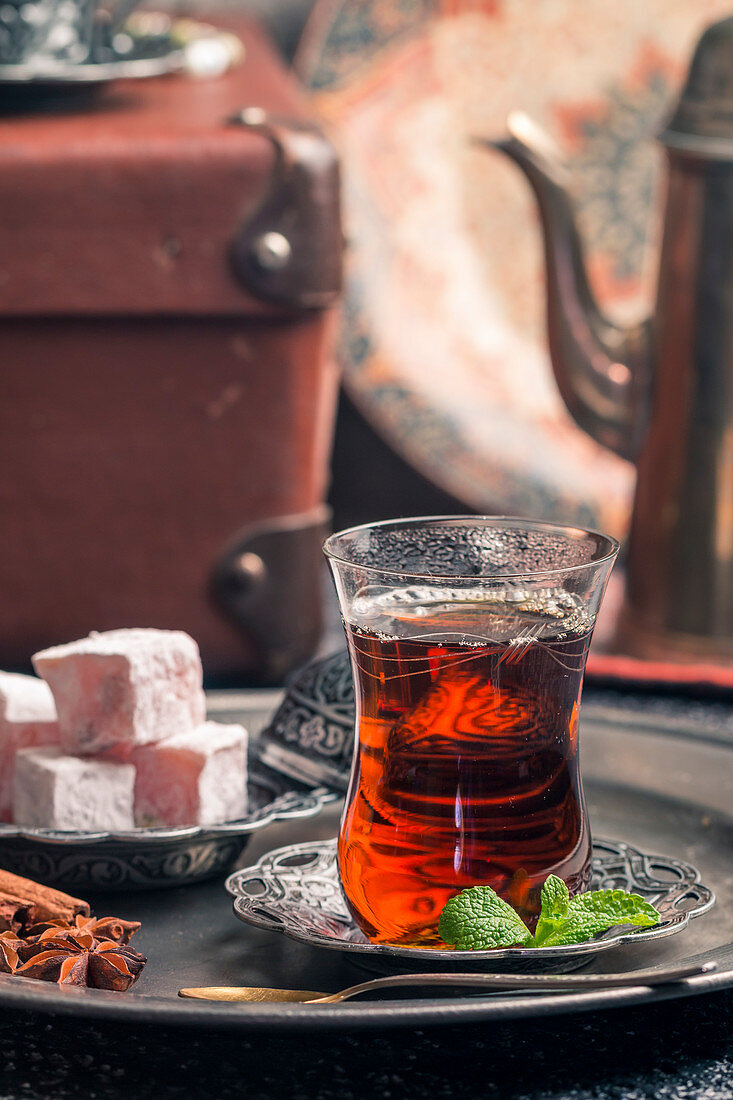 Turkish tea in traditional glass cup with turkish delight