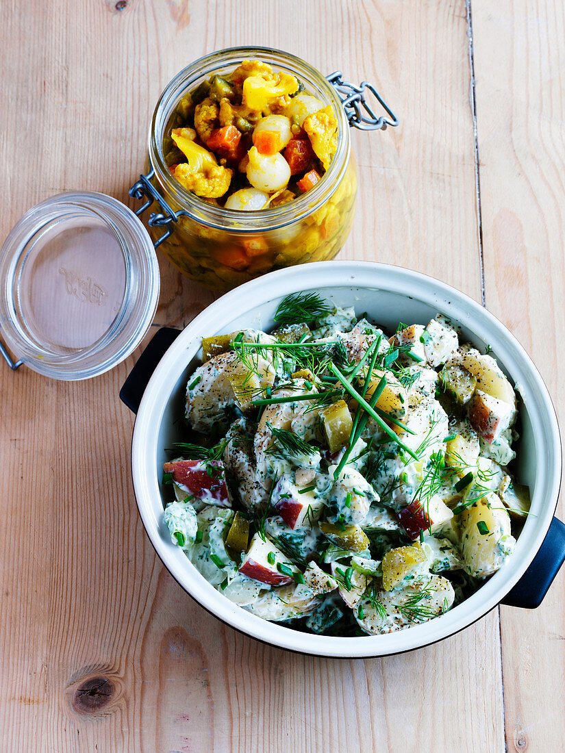 Potato salad with apple and herbs, and a jar of piccalilli