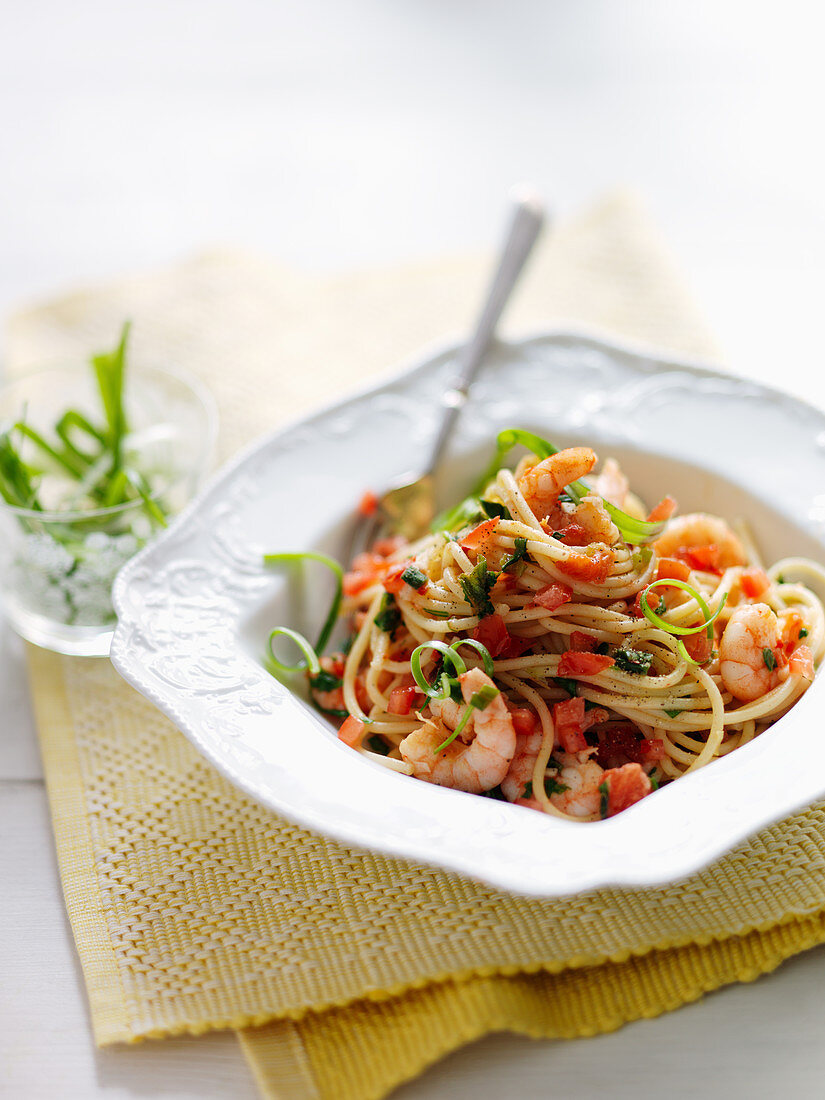 Spaghetti with shrimps, spring onions, garlic and chili