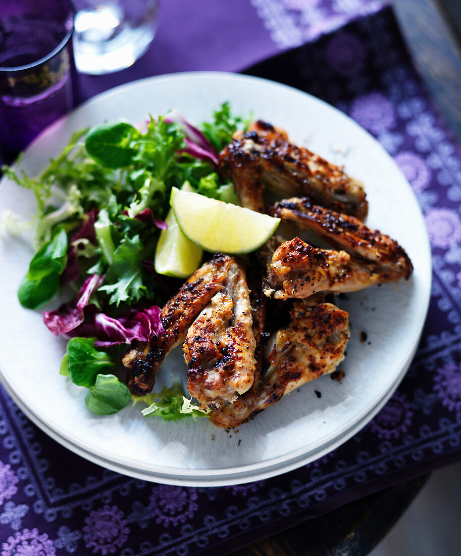 Grilled chicken wings with ginger, lime and salad