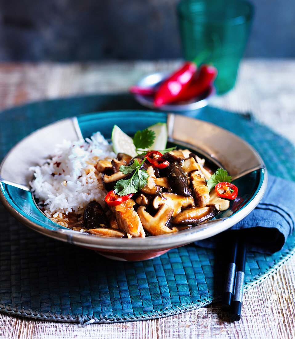 Sweet and sour chicken with mushrooms served with rice (Asia)