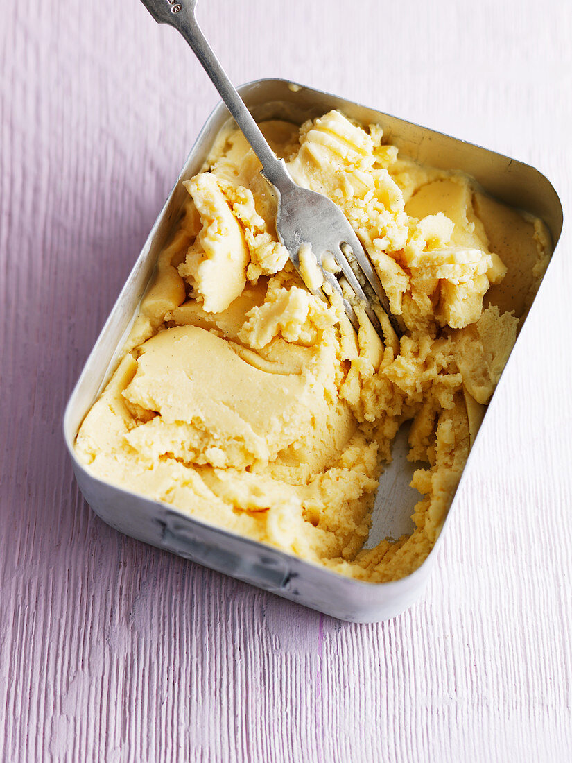 Homemade vanilla ice cream: ice cream being stirred regularly