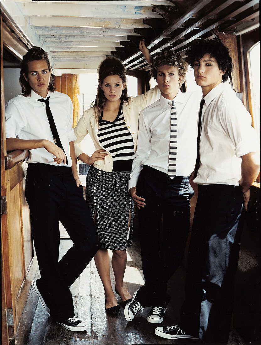 Four young people wearing black-and-white outfits at a bar