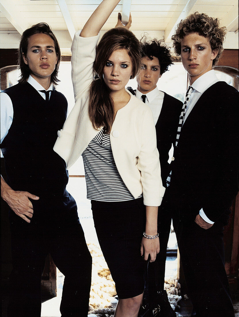 Four young people wearing black-and-white outfits