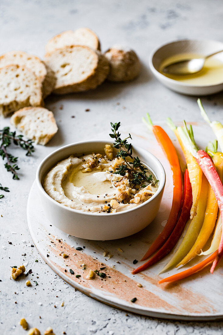 White bean dip with rainbow carrots and homemade bread