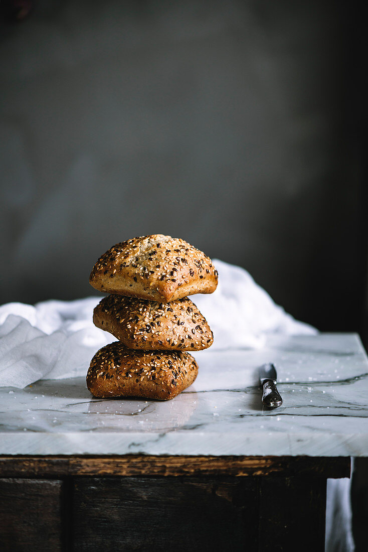 Freshly baked seeded bread rolls in a rustic kitchen