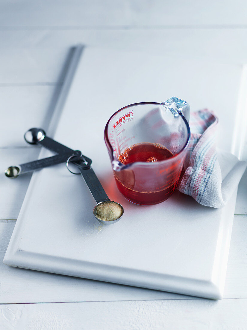 Strawberry sauce in a measuring cup