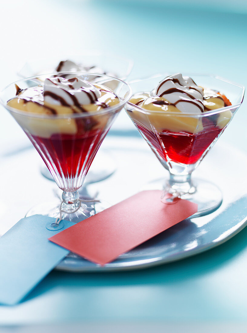 Strawberry trifle with vanilla pudding, cream and chocolate sauce