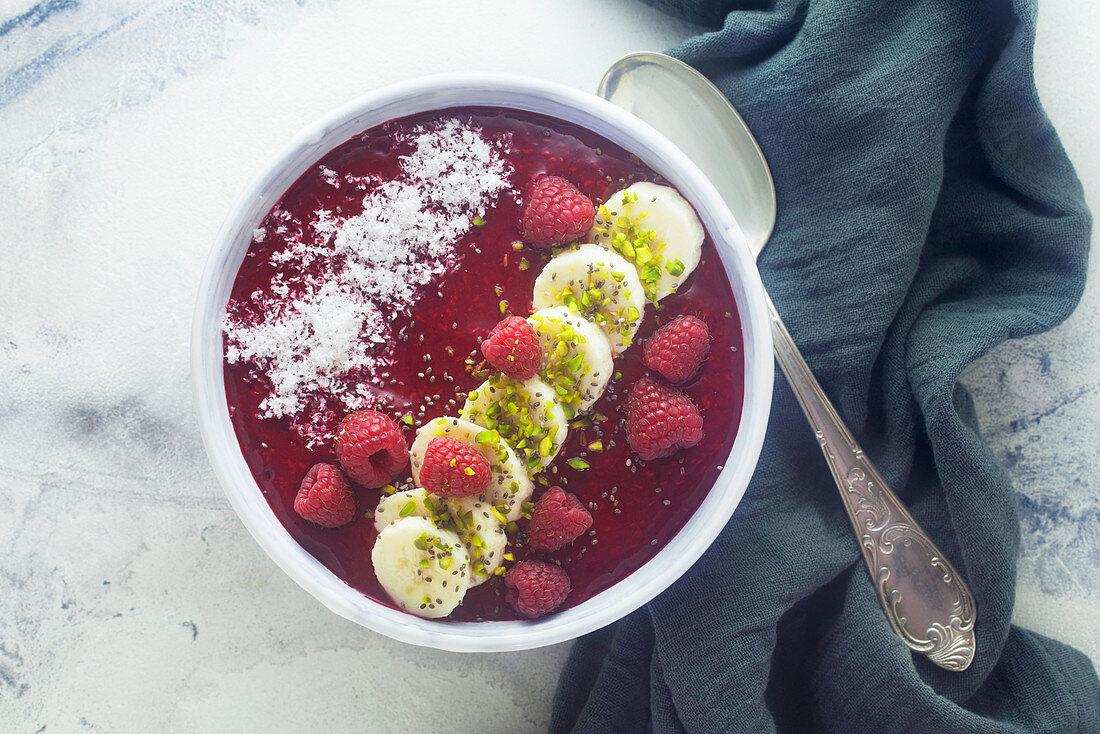 A raspberry smoothie bowl with bananas and coconut