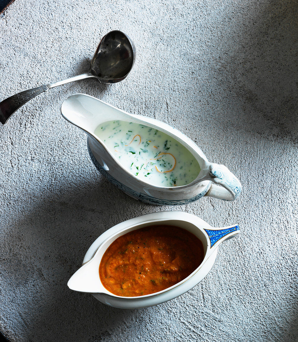 Watercress sauce and tomato sauce in gravy boats