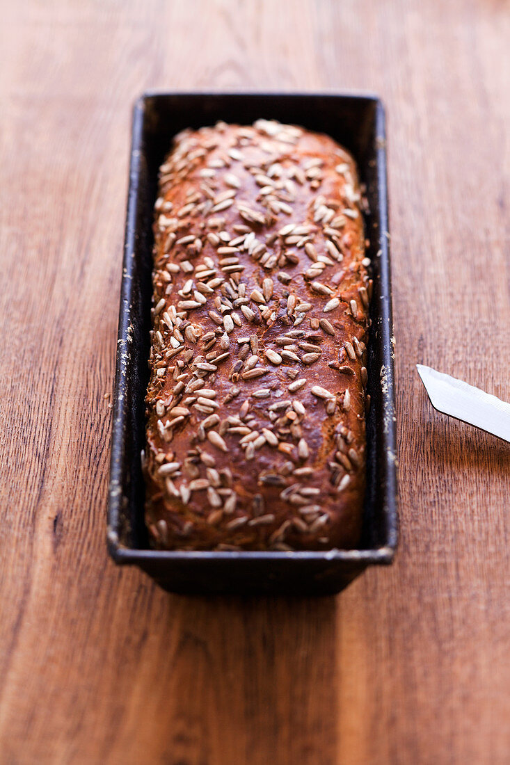 Sunflower seed bread in a loaf tin
