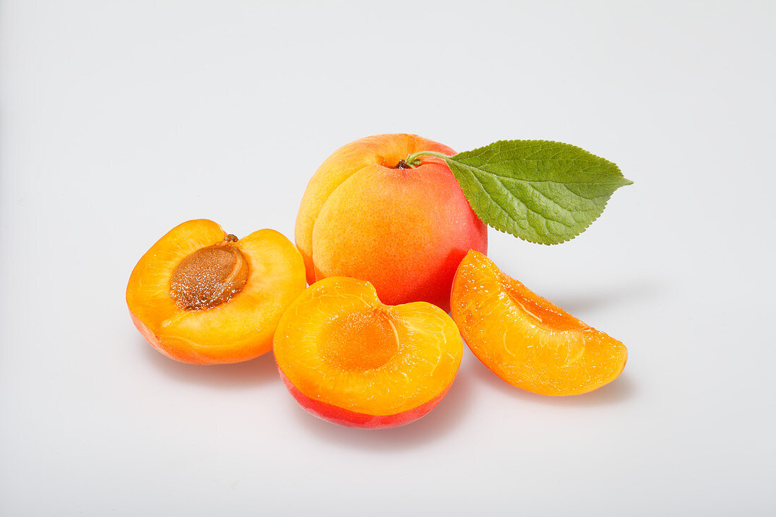 Apricots, whole and sliced, with a leaf