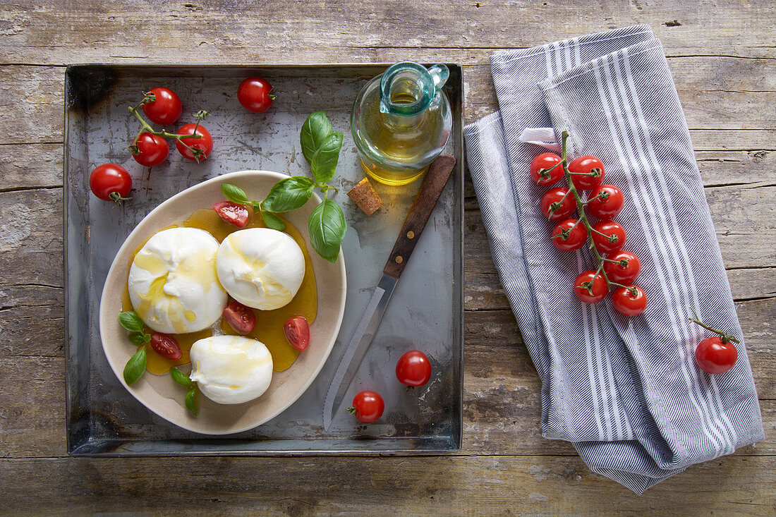 Burrata with olive oil, tomatoes and basil