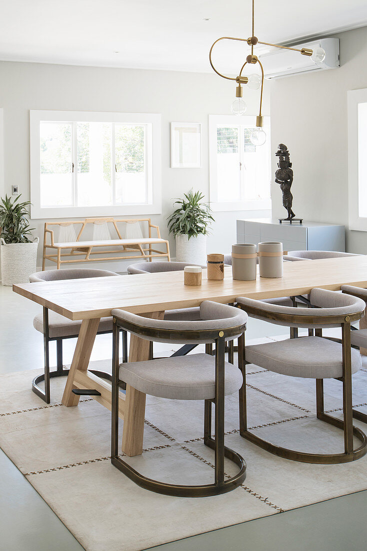 Elegant upholstered chairs around wooden table in grey dining room