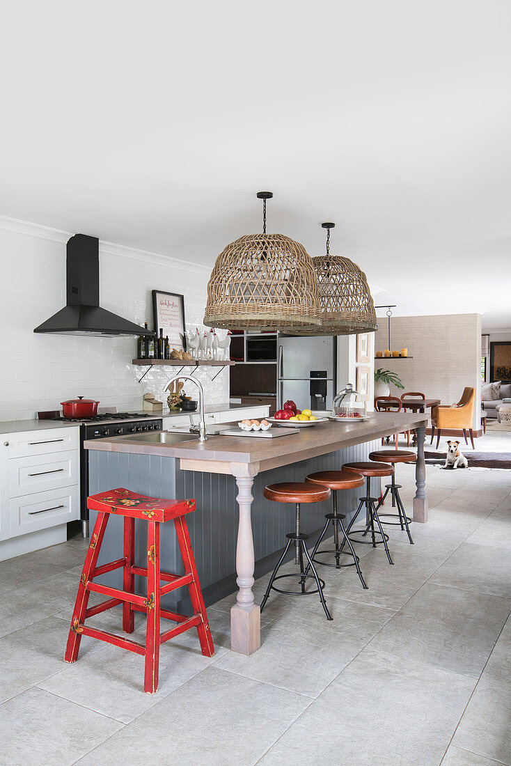 Kitchen counter and barstools in open-plan vintage-style kitchen