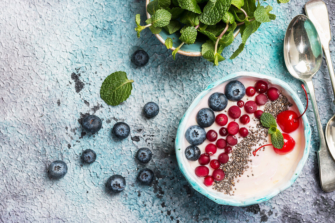 Light greek yogurt dessert with chia seeds, goji and fresh berry served