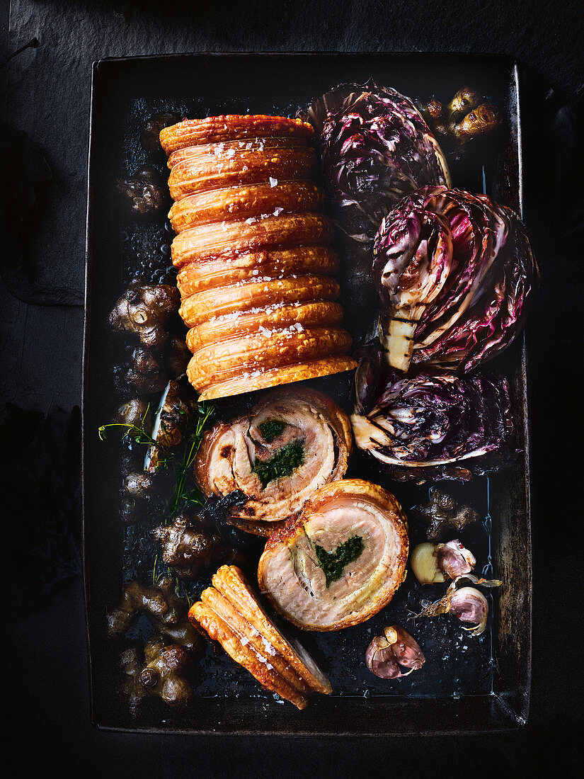 Porchetta (rolled pork belly) with a garlic and herb filling