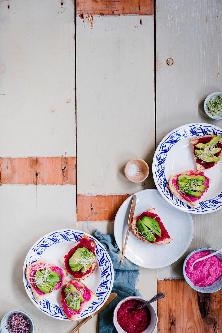 Toast with pink hummus, avocado and vegetable sprouts
