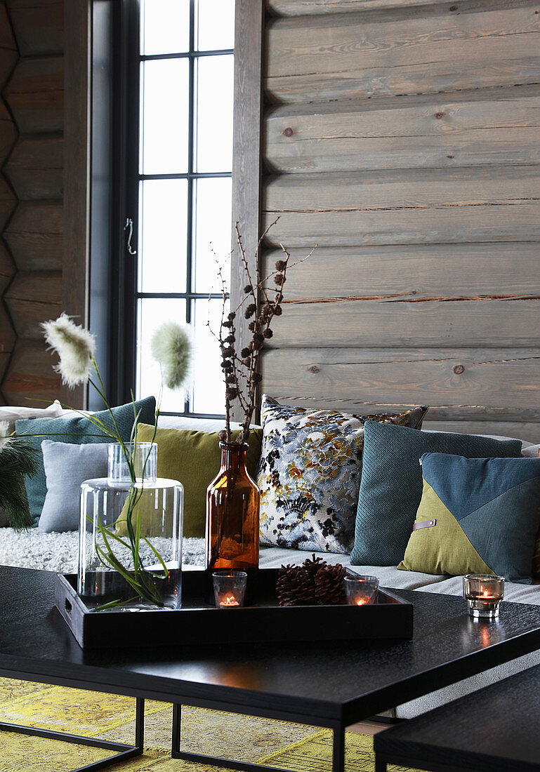 Wintry accessories on coffee table in log cabin