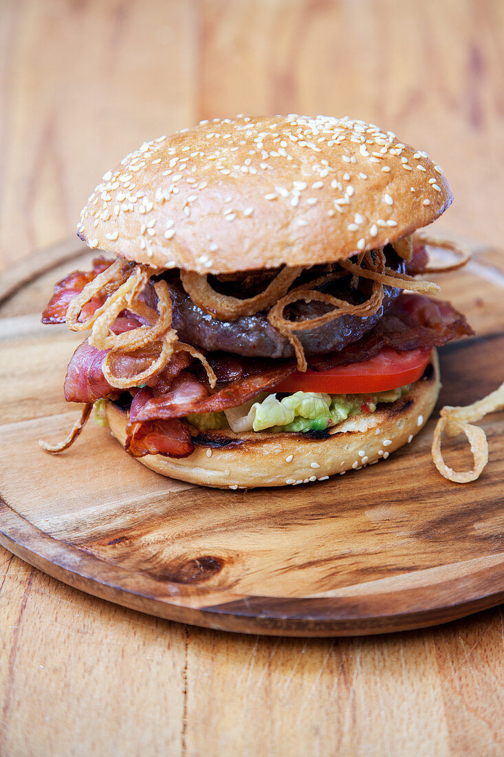 Grilled American range burger with guacamole and BBQ sauce