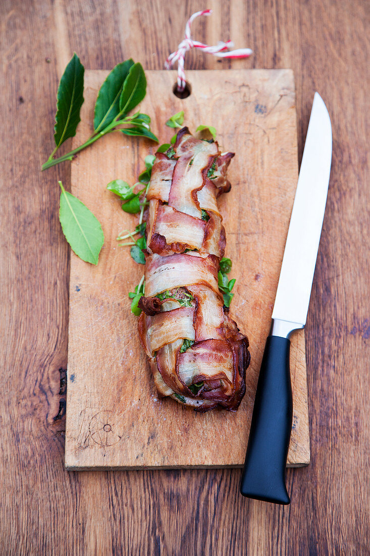 Grilled pork fillet with watercress, wrapped in bacon