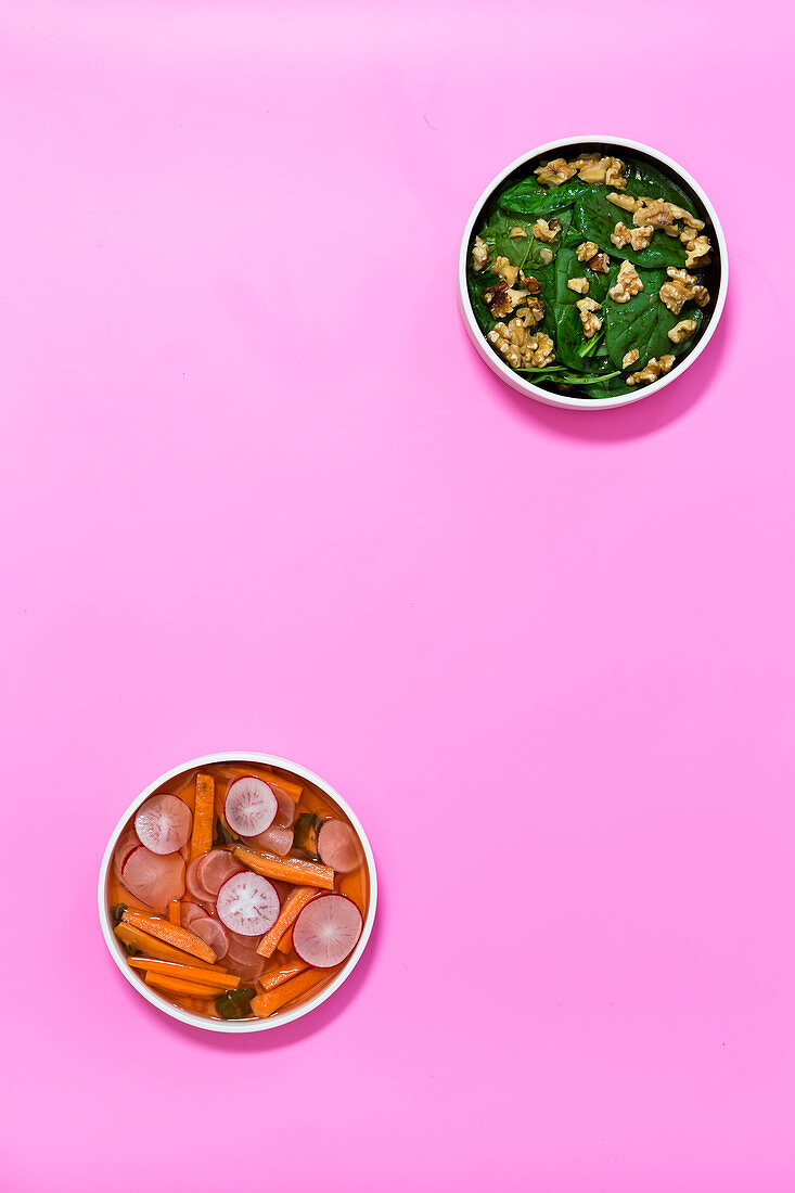 Spinach salad with walnuts, and pickled carrots and radishes