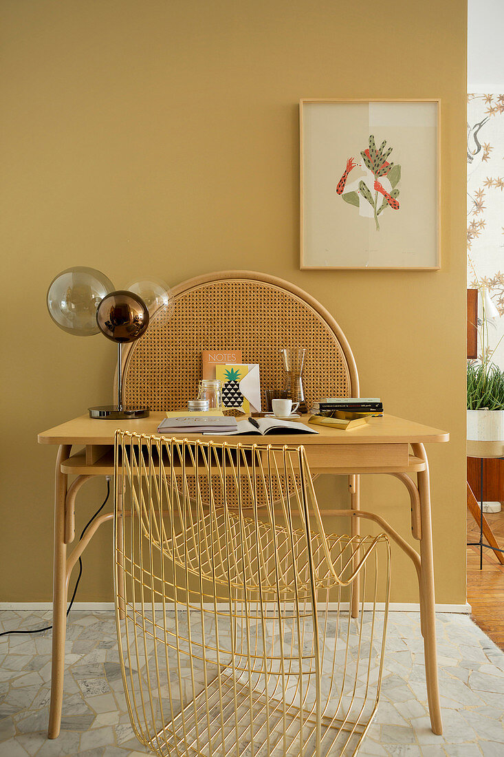 Small desk with table lamp and designer chair