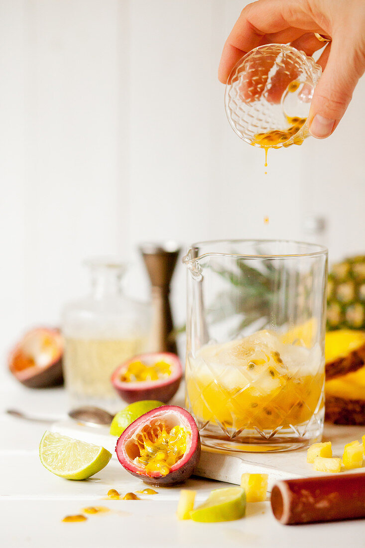 Pouring passionfruit Juice into a Cocktail Jug
