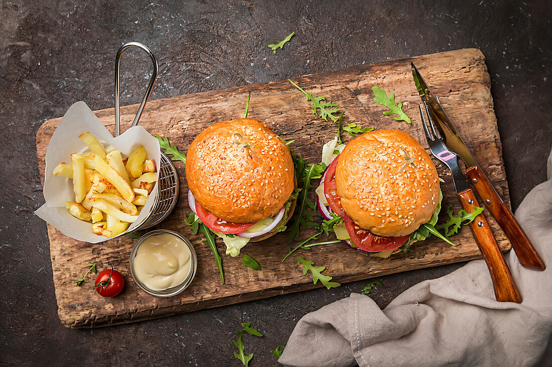 Two tasty grilled classic beef burgers with French fries
