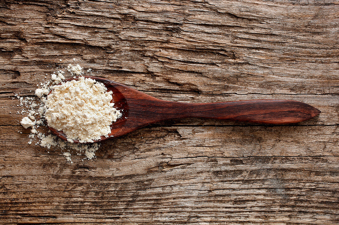 Quinoa flour on a wooden spoon