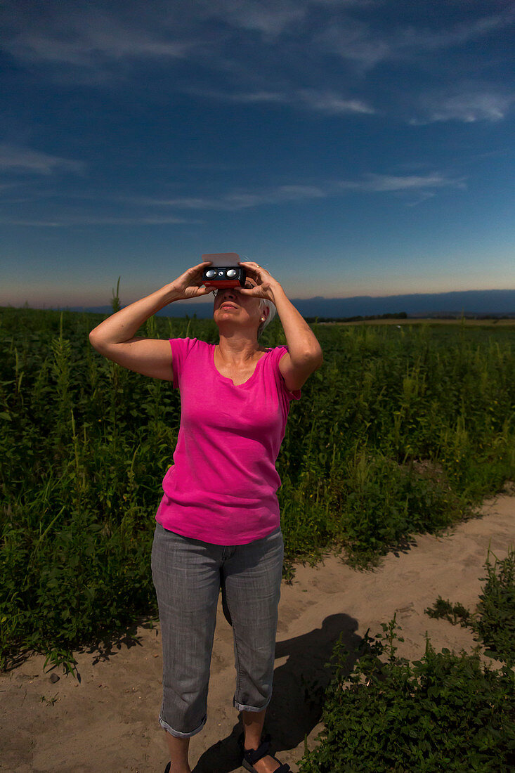 Woman watching total solar eclipse