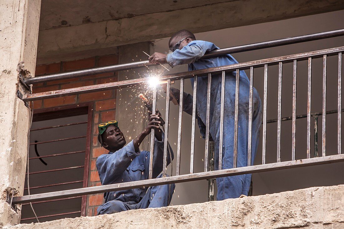 Construction workers welding railings