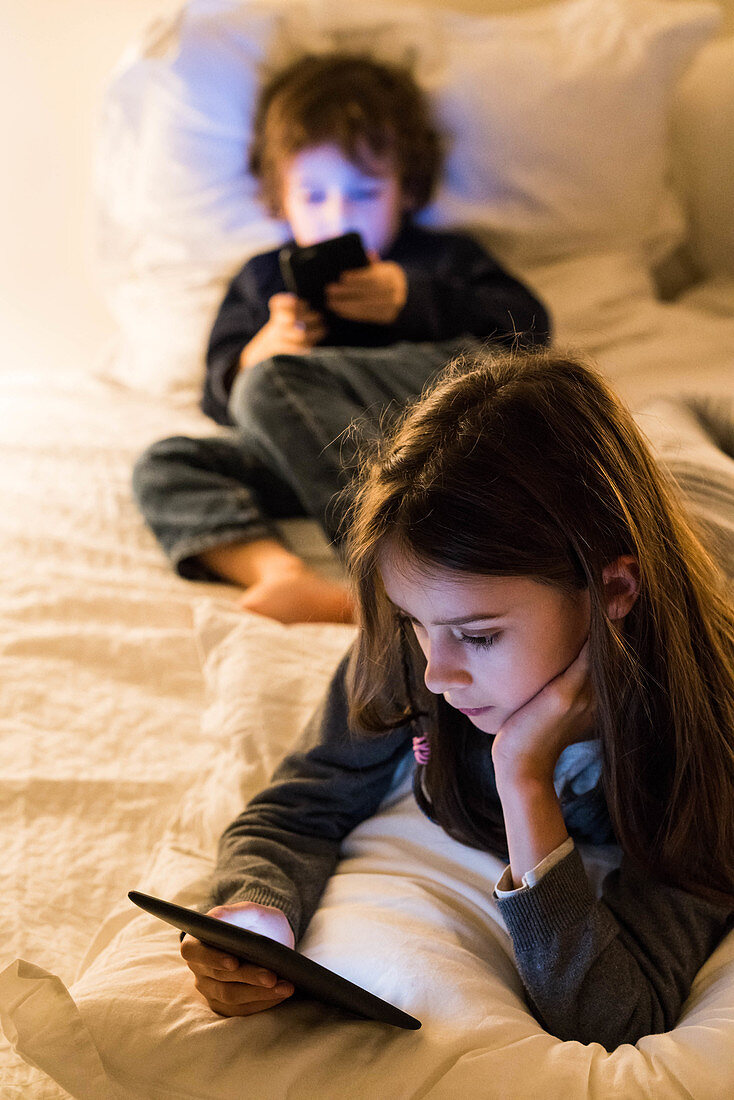 Children using a digital reader and a smartphone