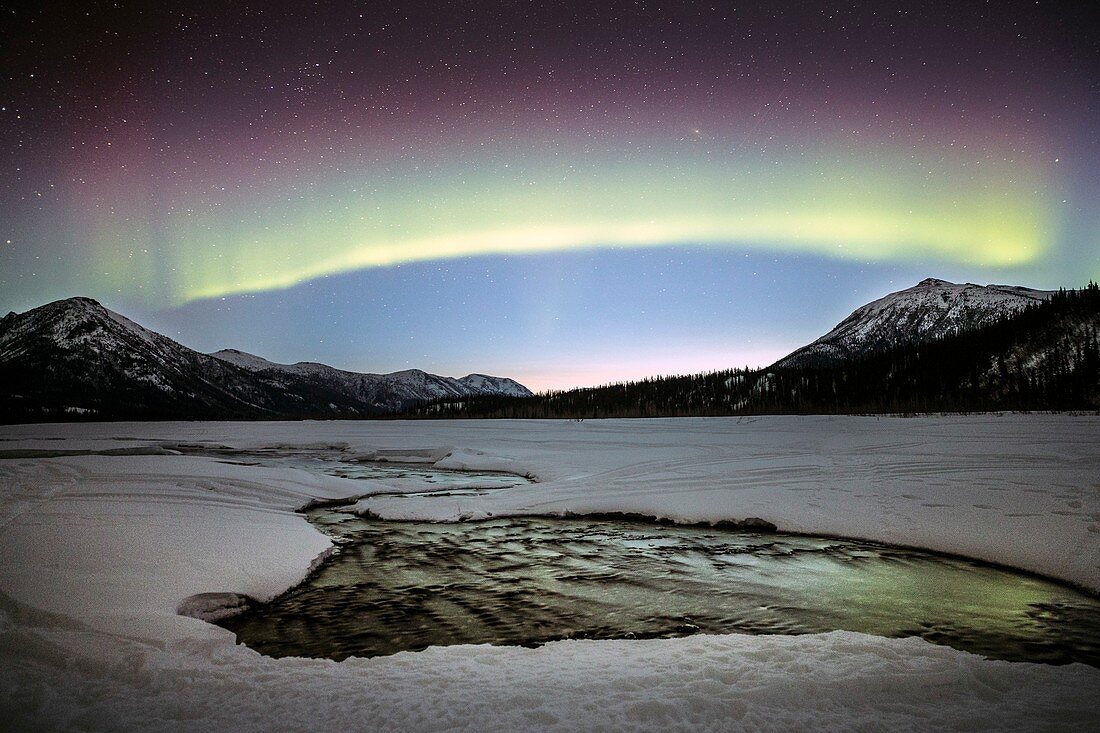 Aurora with dawn breaking over a river