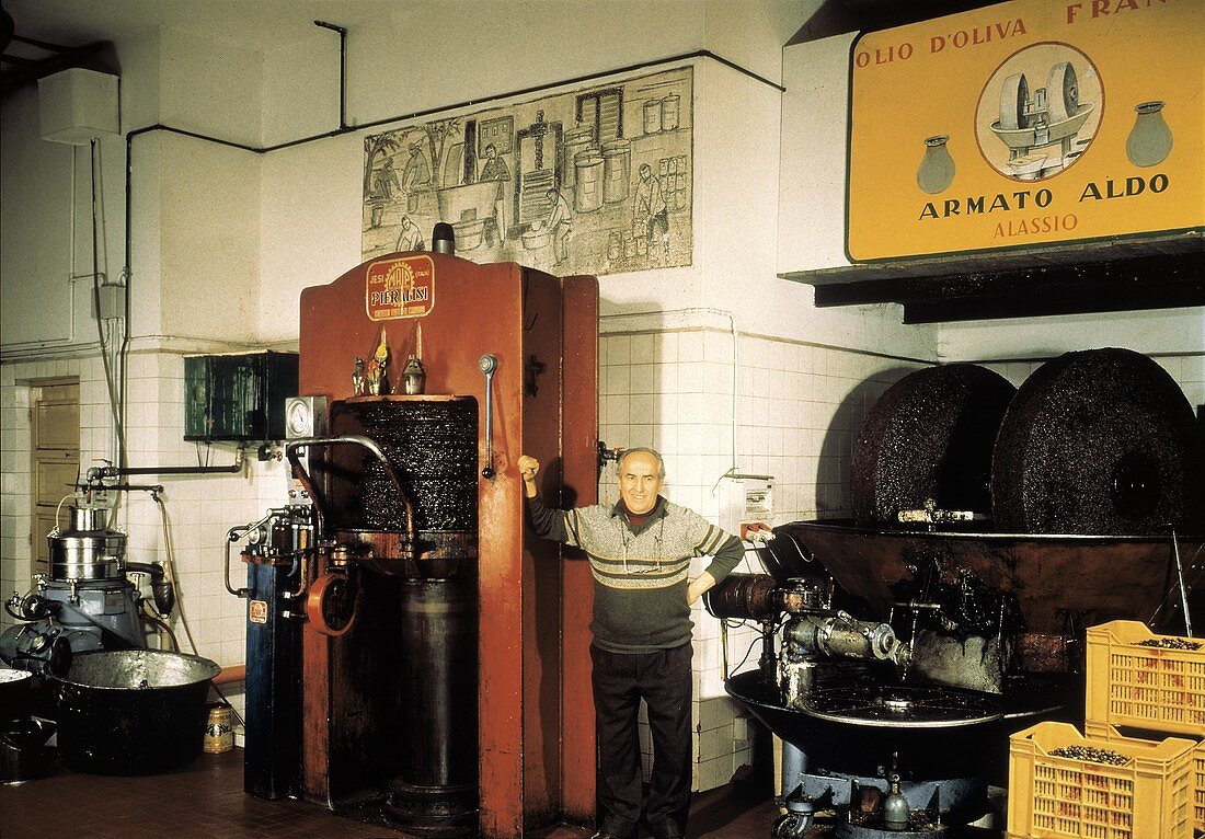 A Man Standing Inside an Olive Oil Factory
