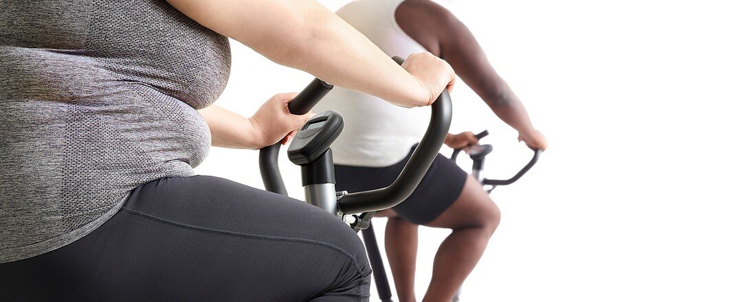 Overweight woman and man on exercise bikes