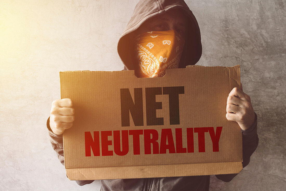 Hooded activist with Net neutrality protest sign
