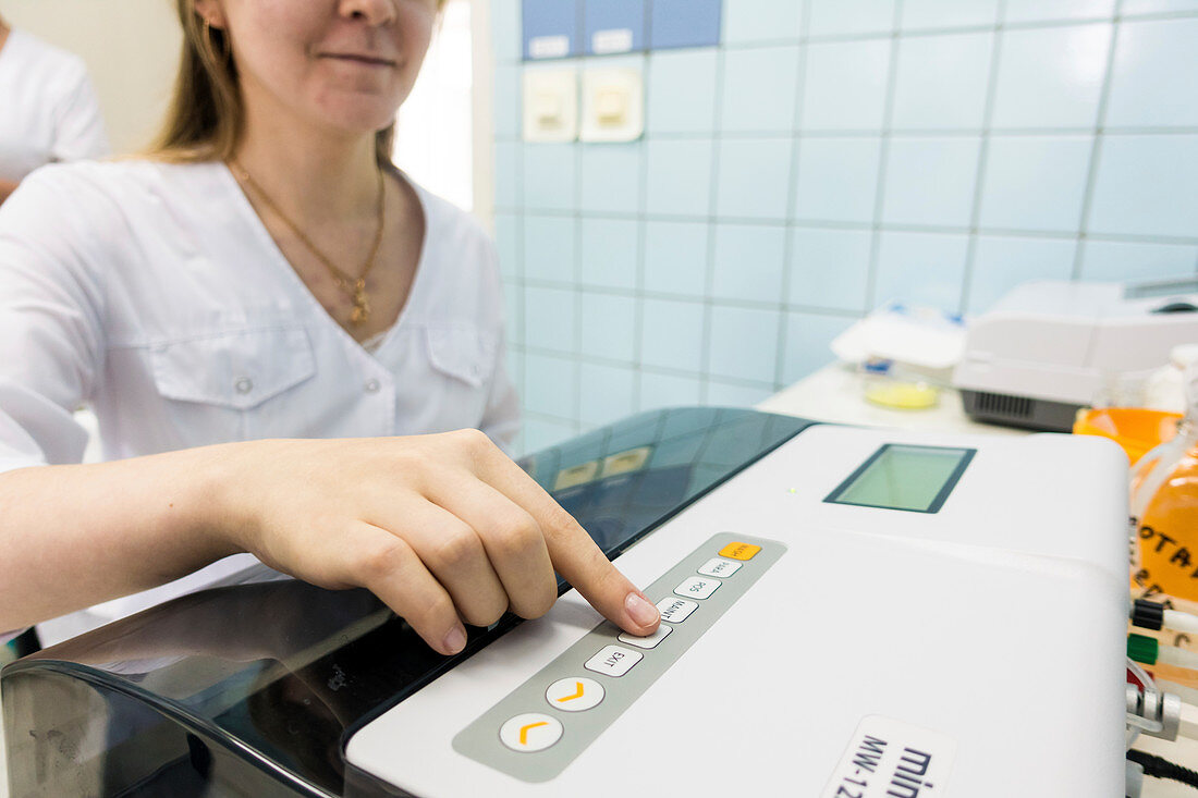 Technician using PCR machine