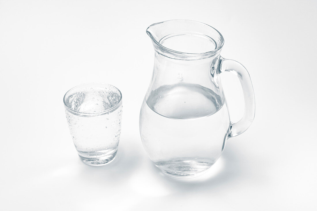 Glass and jug with drinking water