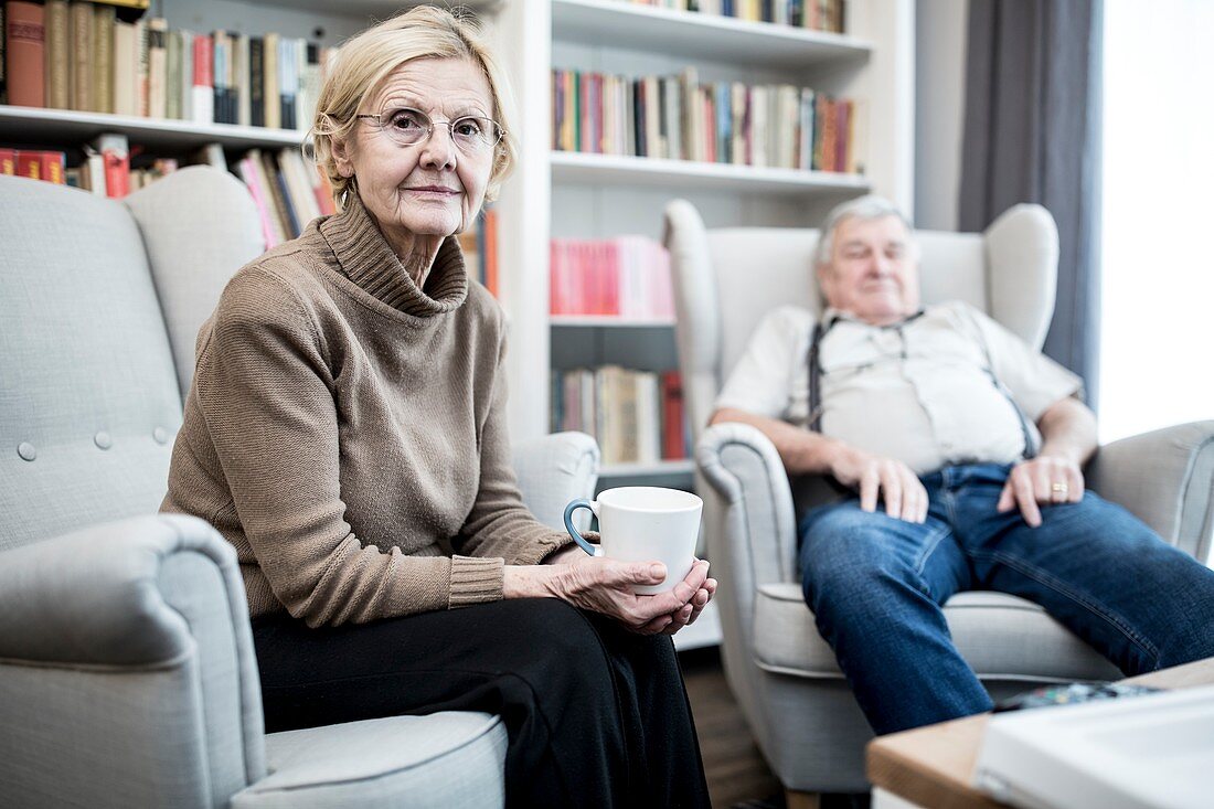 Senior couple sitting on armchairs