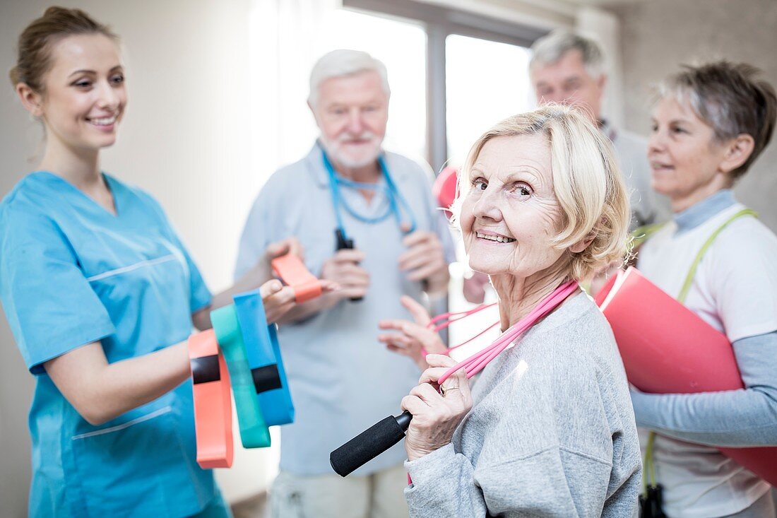 Seniors with physiotherapist in exercise class