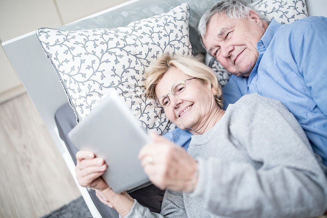 Senior couple looking at tablet