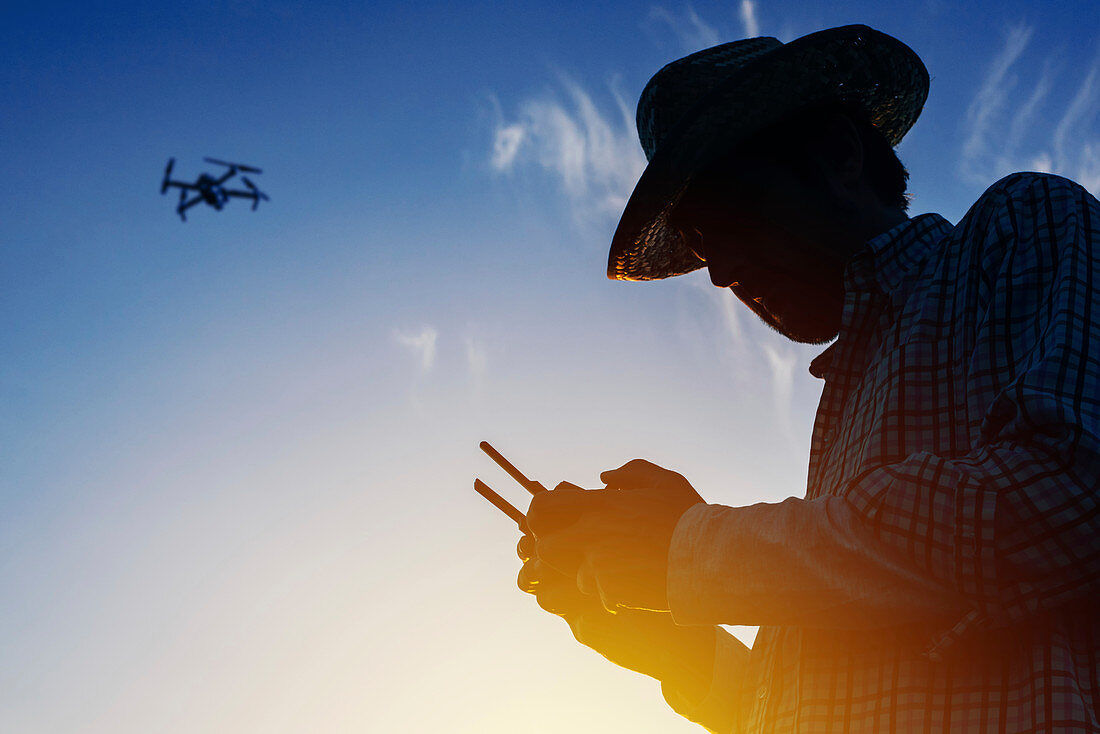 Farmer piloting drone