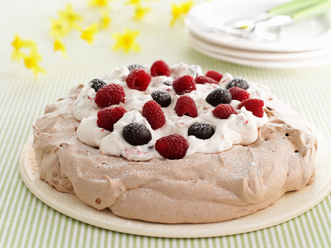 Pavlova with chocolate eggs and raspberries for Easter