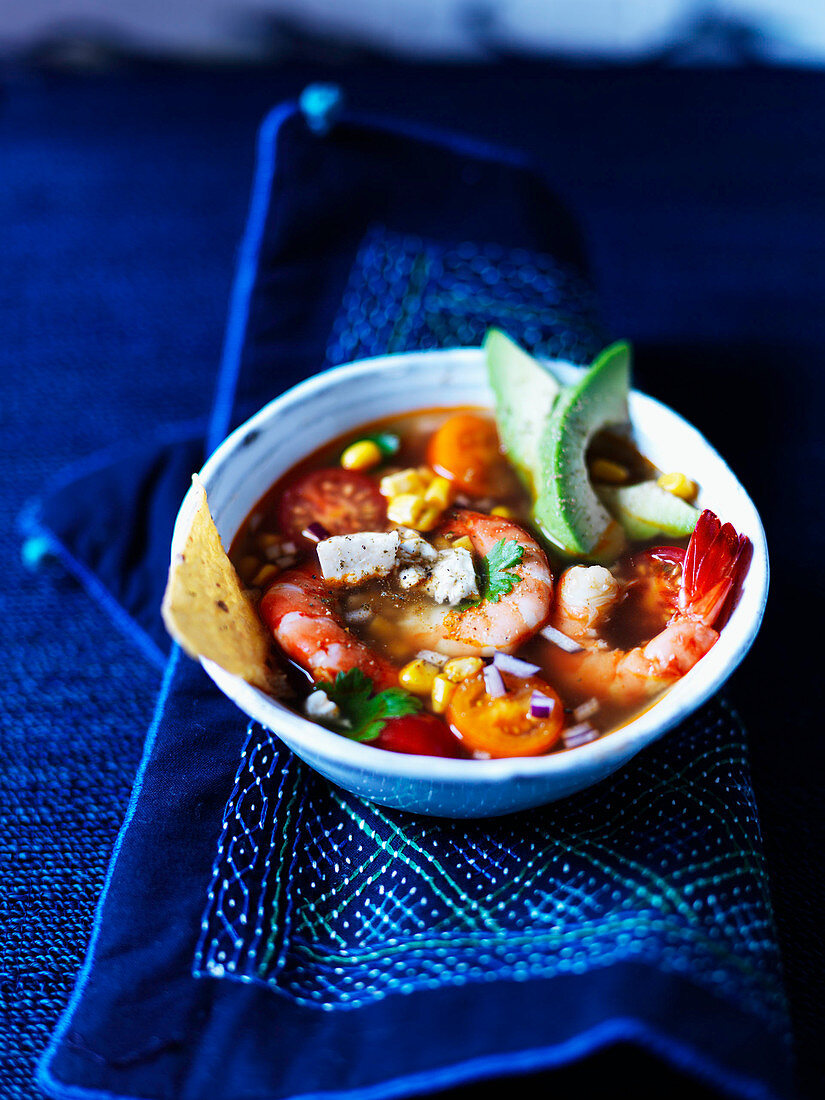 Prawn soup with cherry tomatoes, corn, nachos, and avocado (Mexico)