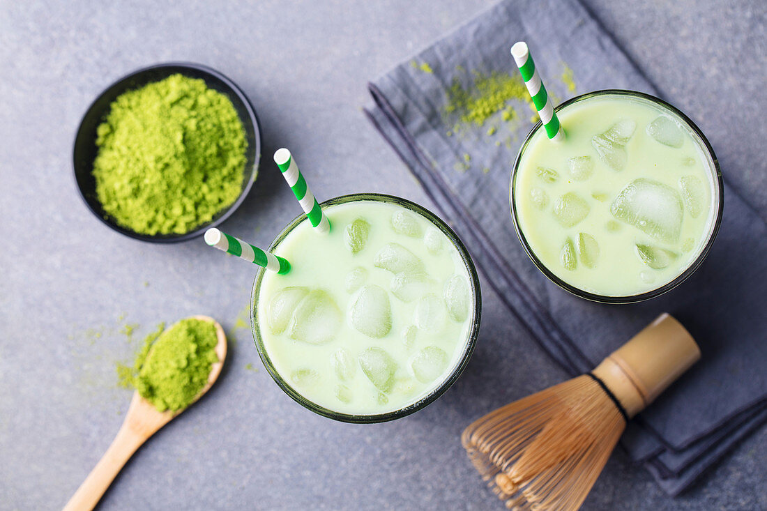 Matcha green tea ice latte with matcha powder and bamboo whisk