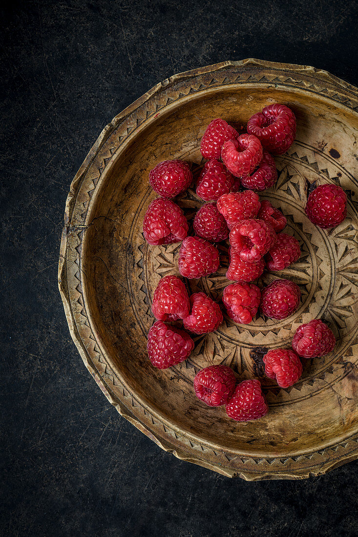 Raspberries on a wooden plate