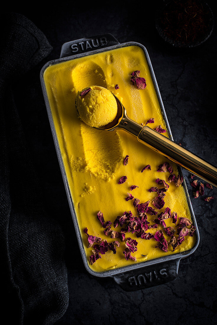 Persian saffron ice cream (Bastani Sonati) with rose petals in an ice box