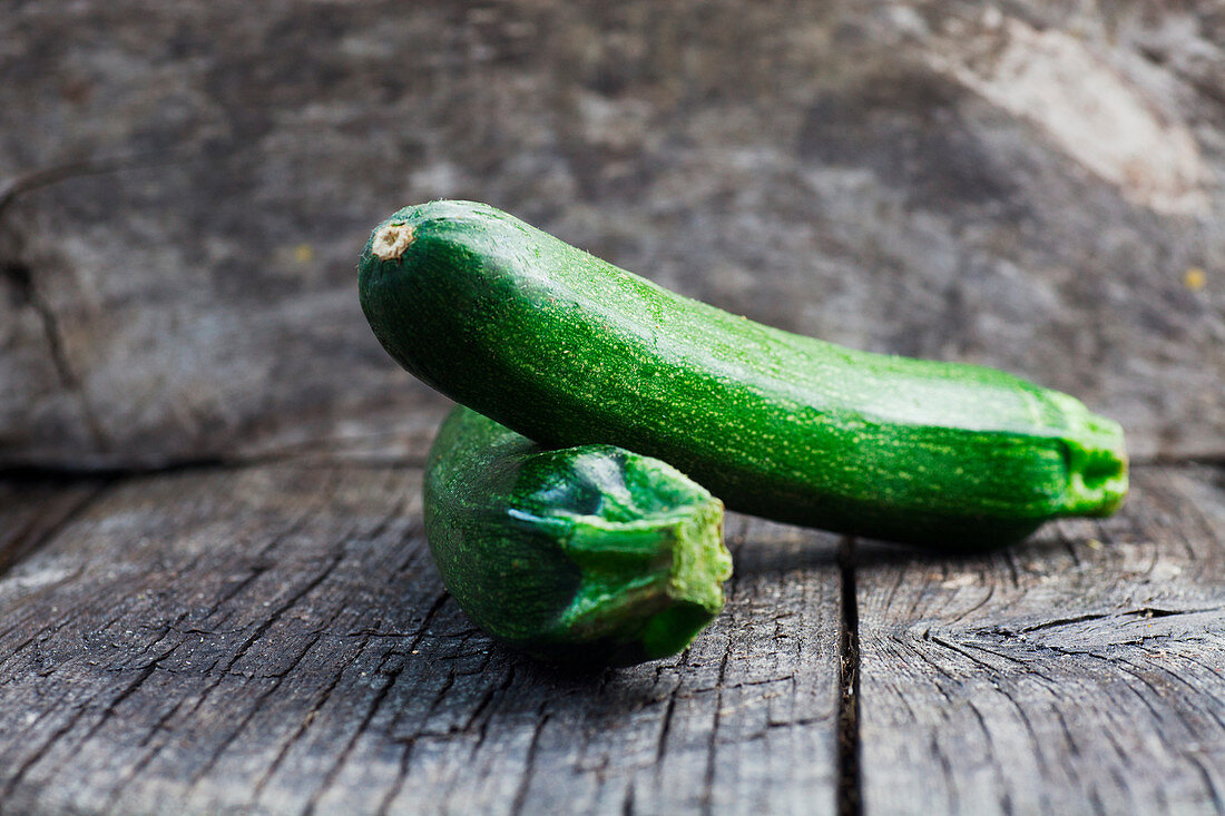 Fresh green zucchini on wood in vintage setting